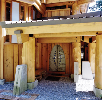Mann designed the front door to be like a cave entrance. To enter, visitors must bow slightly, a simple act that emphasizes the home's spiritual presence and permanence.